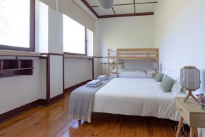 A bed or beds in a room at Loriga Hostel - Feel Nature