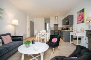 a living room with a couch and a table at Logis des Halles du Coderc in Périgueux