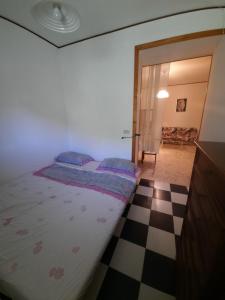 a bedroom with a bed and a checkered floor at Cilento e mare in Rodio