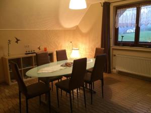 a dining room with a table and chairs at Ferienwohnung-Michels in Orlenbach