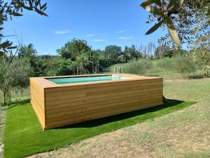 a swimming pool with a wooden deck in a yard at Casa Calicanto in Corropoli