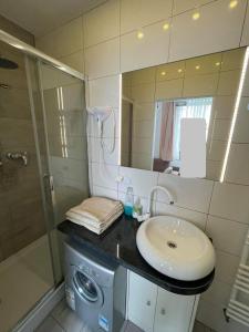 a bathroom with a sink and a washing machine at Gdynia99 in Gdynia
