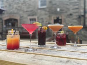 a group of four cocktails on a wooden table at Royal Dunkeld Hotel in Dunkeld +29 photos