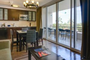 a kitchen and living room with a table and chairs at Regency on Beachwalk Waikiki by OUTRIGGER in Honolulu