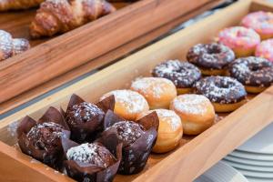 a tray of different types of donuts on display at Hotel Baby in Rimini