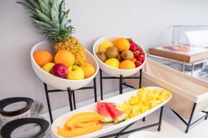 three bowls of fruit on display on a table at Hotel Baby in Rimini