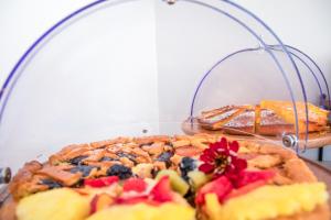 a pie with fruit on top of a table at Hotel Baby in Rimini