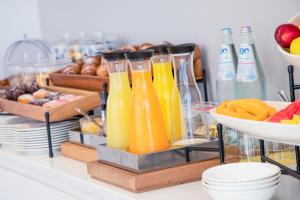 a buffet with bottles of orange juice and fruit at Hotel Baby in Rimini