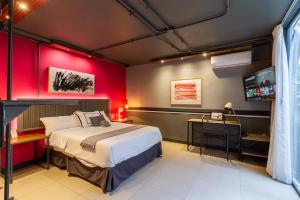a bedroom with a bed and a red wall at The Yellow by DOT Boutique in Guadalajara