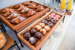 a bunch of different types of donuts and pastries on display at Hotel Baby in Rimini