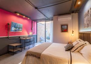 a bedroom with a large bed and a red wall at The Yellow by DOT Boutique in Guadalajara