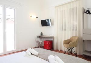 Televízia a/alebo spoločenská miestnosť v ubytovaní Casa Maja rooms & suites