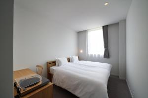 Postel nebo postele na pokoji v ubytování MUSTARD HOTEL SHIMOKITAZAWA