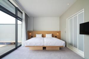 Postel nebo postele na pokoji v ubytování MUSTARD HOTEL SHIMOKITAZAWA