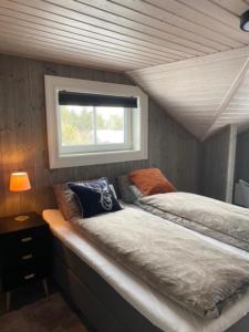 a room with two beds and a window at Villa Solsiden Geilo in Geilo
