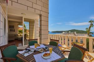 a patio with a table and chairs on a balcony at Hedera Estate, Hedera A39 in Dubrovnik