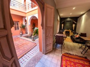 a hallway with an open door and a living room at Riad Tahani in Marrakesh