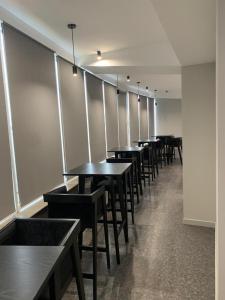 a row of tables and benches in a restaurant at Red Cube Hotel in Kamianets-Podilskyi