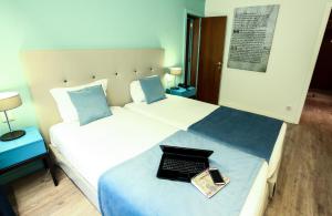 Uma cama ou camas num quarto em Grão Vasco - Historic Hotel and SPA