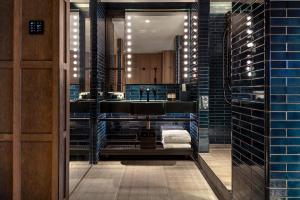 a bathroom with a sink and a mirror at The Londoner in London