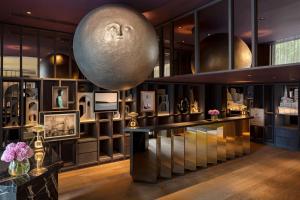 a room with a large orb on the wall at The Londoner in London +48 photos
