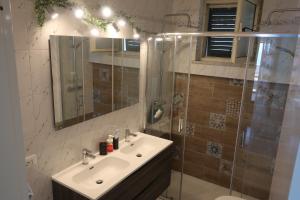 a bathroom with a sink and a shower with a mirror at Turchese in Amalfi