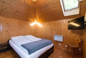 a bedroom with a bed in a wooden cabin at Domek na Stoku in Kazimierz Dolny