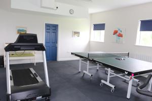 a ping pong table in a room with a ping pong table at Laneside Haven - 5 Minutes from Castleblayney - Accessible, Gated with Patio, Garden and Gym! in Monaghan