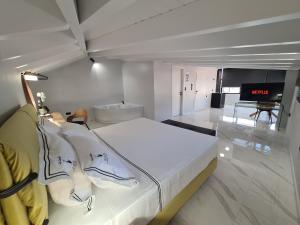 a bedroom with a large white bed in a room at ILIA'S Luxury Suites in Xylokastron