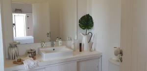 a bathroom with a white sink and a mirror at Comporta House in Comporta +37 photos