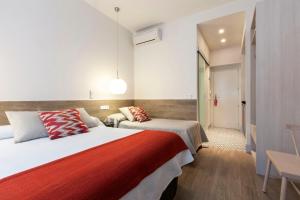 a hotel room with two beds and a couch at LOFTS Puerta del SOL in Madrid