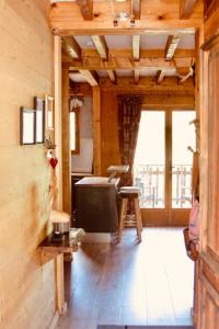 a kitchen with wooden walls and a wooden floor at Chalet Le Bouton D'or in Les Deux Alpes