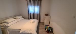 a small bedroom with two beds and a window at Holiday Home Ivo in Sevid
