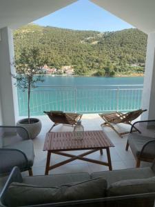 a living room with a view of the water at Apartments Vala in Grebaštica