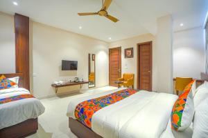 a hotel room with two beds and a tv at FabHotel Prime Empire in Amritsar