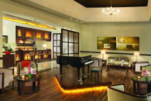 a living room with a piano in the middle of a room at Secrets St. James in Montego Bay
