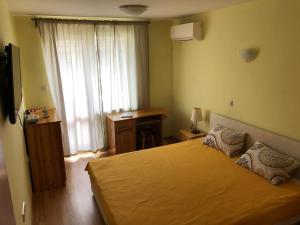a bedroom with a large bed and a window at Cosy Apartment with beautiful terrace in the heart of Varna in Varna City