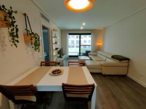 a living room with a table and a couch at NON STRESS First Level in Valencia