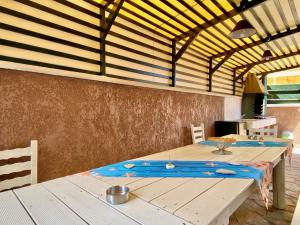 a dining room with a wooden table in a house at Villa Plastiras Sidari with private pool in Sidari