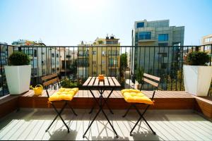 a balcony with a table and chairs on a balcony at Hilton Beach by Five Stay in Tel Aviv