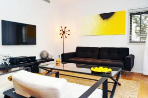 a living room with a couch and a table at Hilton Beach by Five Stay in Tel Aviv