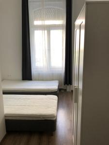 a bedroom with a bed and a window at Omega Apartments Budapest in Budapest