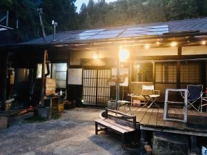 a house with a bench in front of it at ikkyu rental vacation house in Kobune