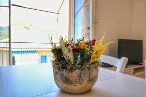 a vase filled with flowers sitting on a table at La Pulce Salata in Levanto