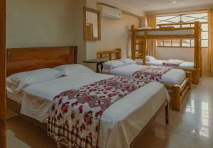 Postel nebo postele na pokoji v ubytování Hostal Poseidon