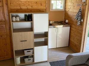 a small kitchen with a white refrigerator and cabinets at Metskonna Forest House in Nõva