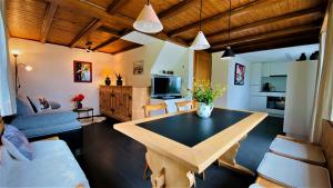 a living room with a table and a couch at Casa Fluretta in Flumserberg