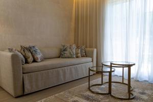 a living room with a couch and two tables at Vila Alba Resort in Carvoeiro