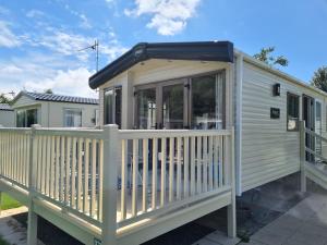 a tiny house with a solarium on a deck at The Hideaway in Grange Over Sands