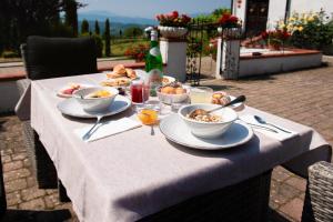 a table topped with plates and bowls of food at Podere Belvedere in Barberino di Mugello